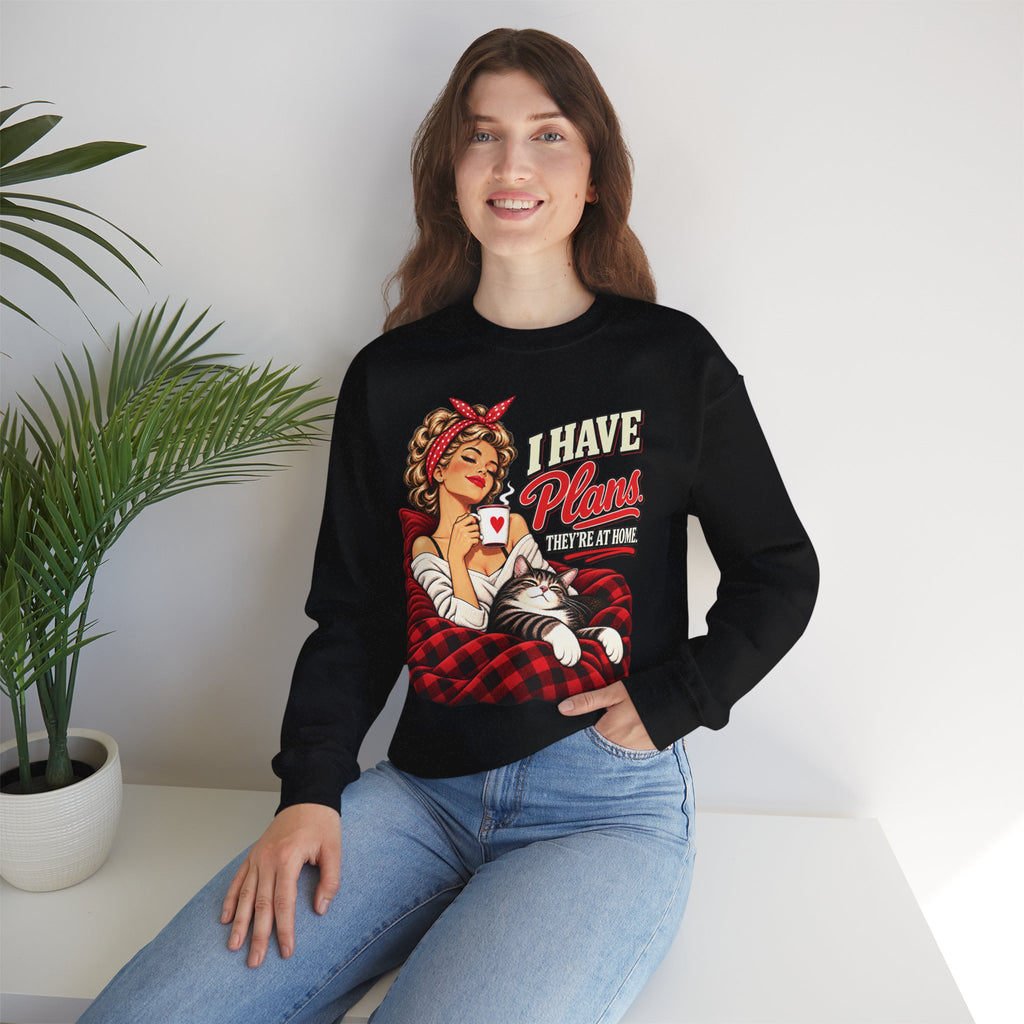 Woman wearing a black retro cat lover sweatshirt with I Have Plans They’re at Home graphic and jeans.
