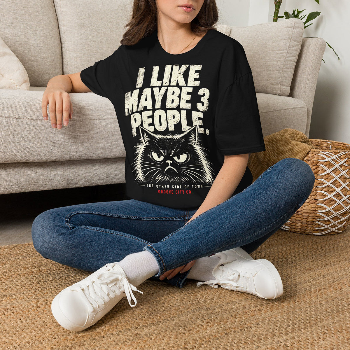 Woman wearing I Like Maybe 3 People grumpy cat T-shirt at home.