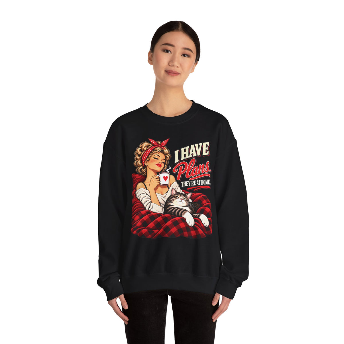 Woman wearing a black unisex cat sweatshirt with retro I Have Plans They’re at Home graphic.