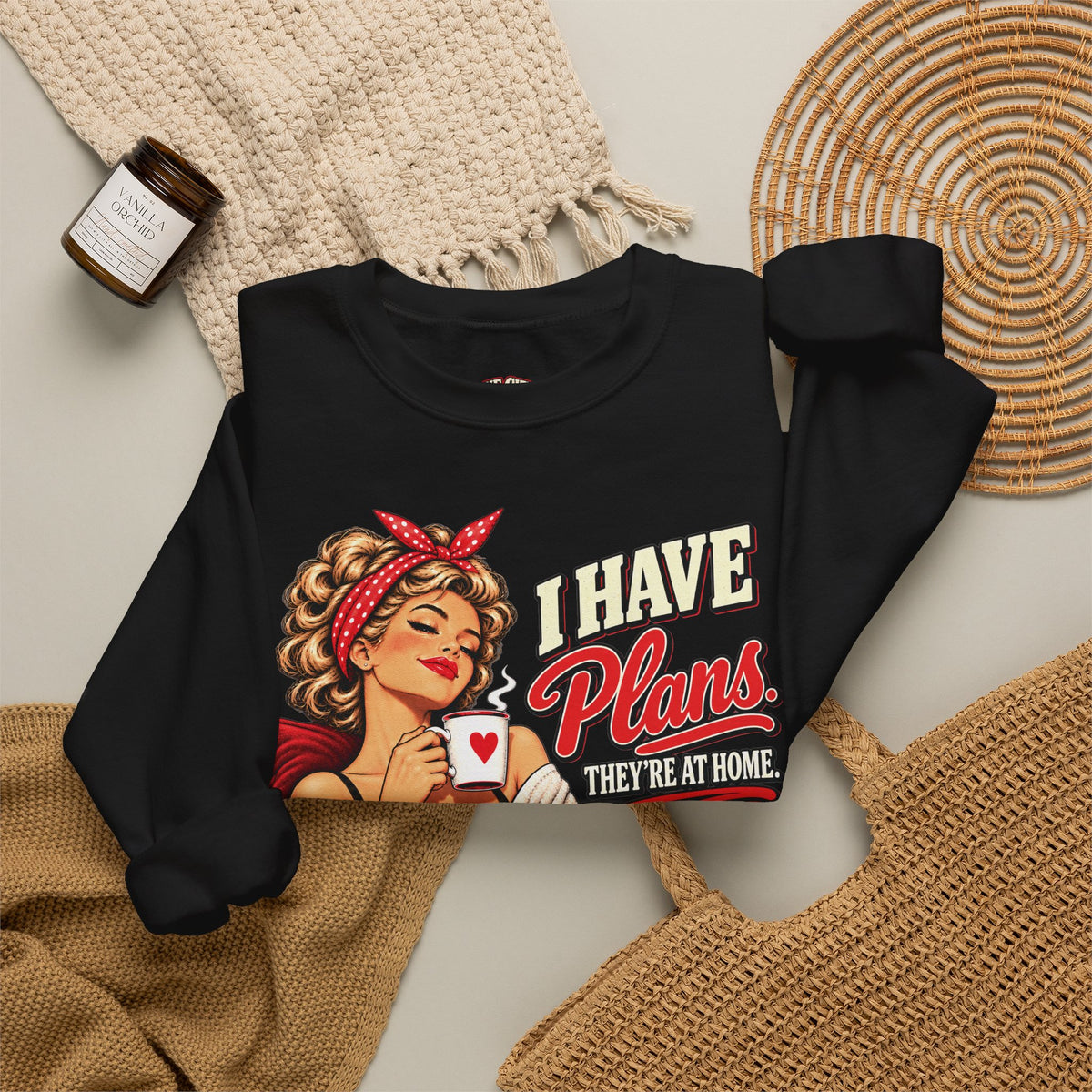 Black retro cat lover sweatshirt with I Have Plans They’re at Home graphic in a cozy flat lay.