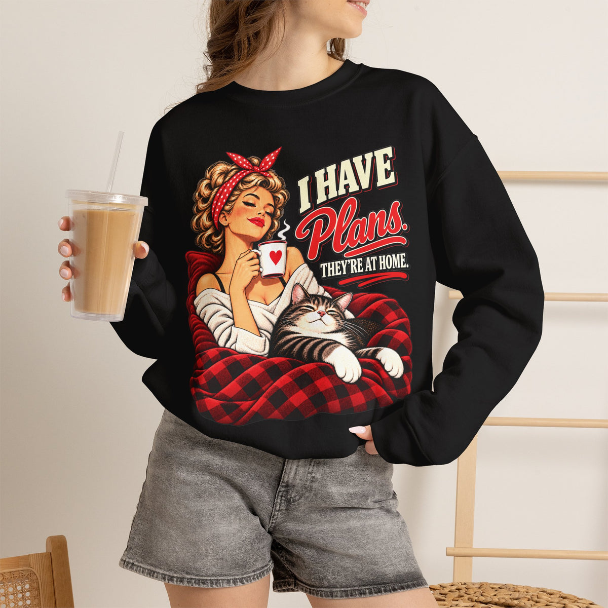 Woman wearing a black retro cat lover sweatshirt with I Have Plans They’re at Home graphic.