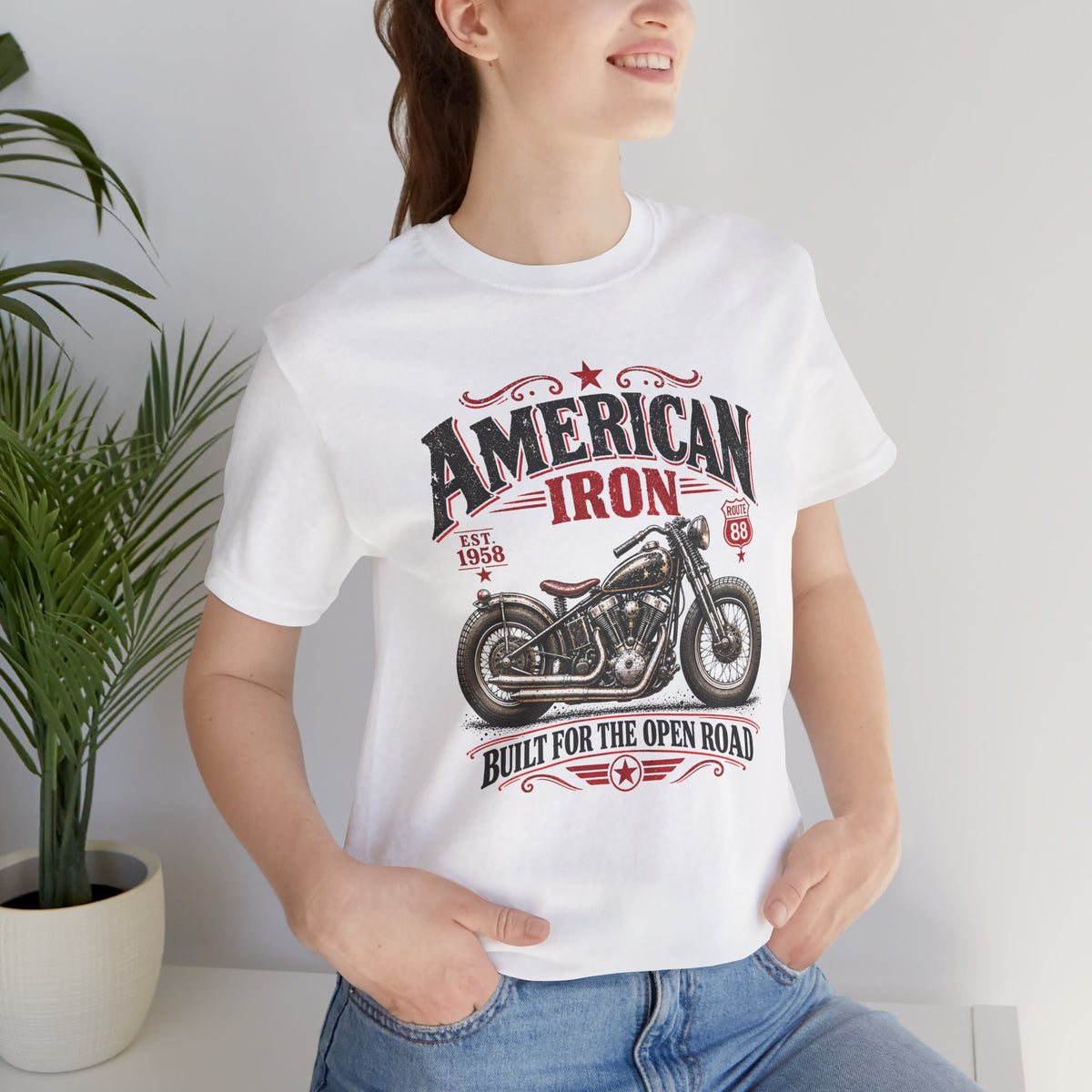 Woman wearing a white American Iron vintage motorcycle t-shirt with classic bobber artwork, Route 88 details and retro biker design by Groove City Co.