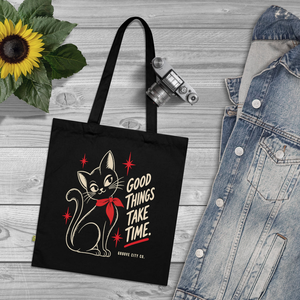 Black vintage cat tote bag with Good Things Take Time print, displayed alongside a denim jacket and retro camera – Groove City Co.